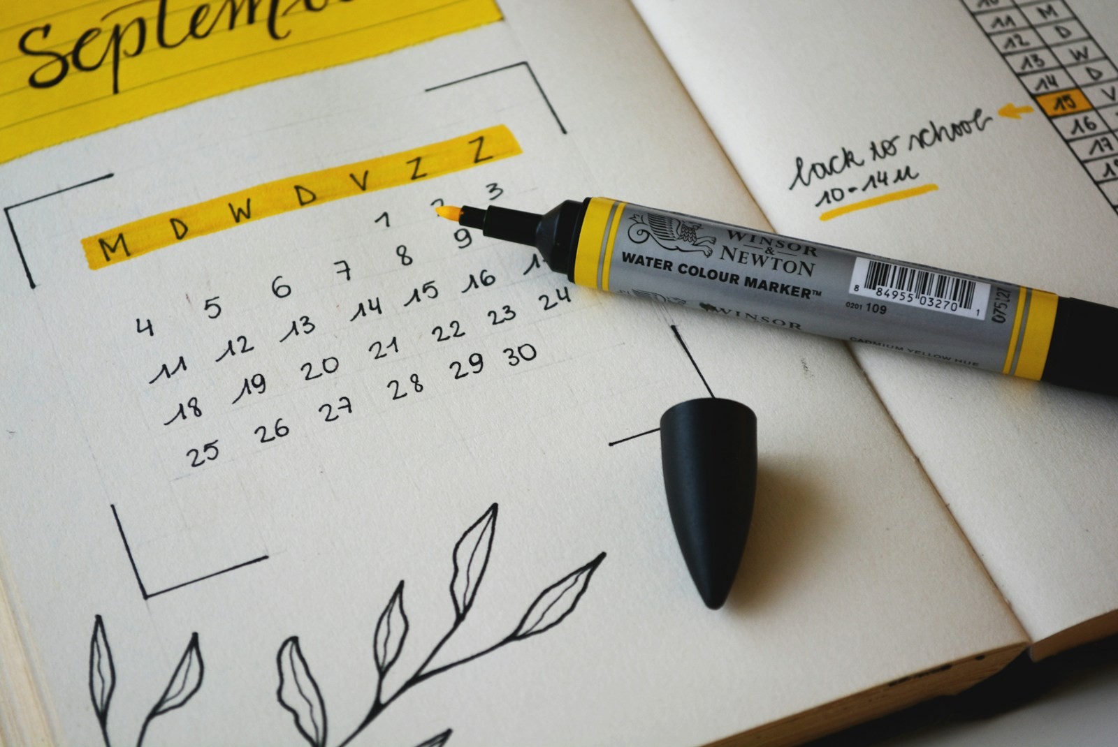 Hand-drawn monthly calendar in a bullet journal