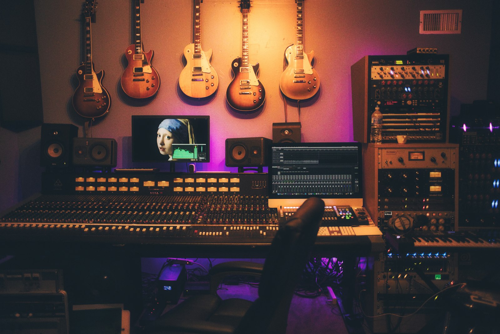 Music production studio with mixing desk and guitars